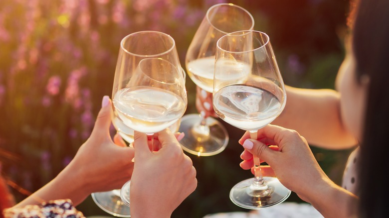 women cheers with white wine