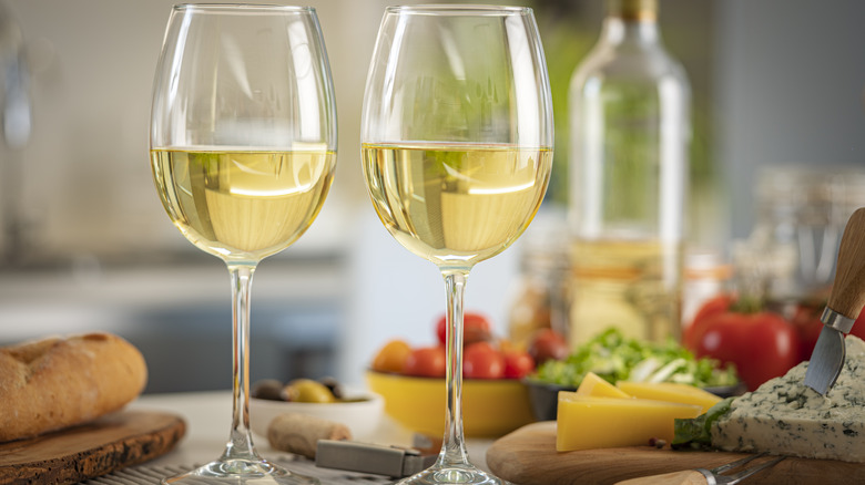 glasses of white wine with cheese board