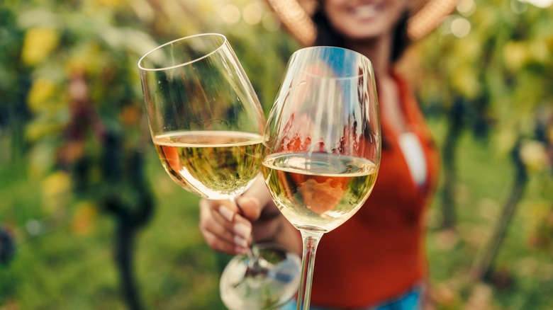 woman cheersing with white wine