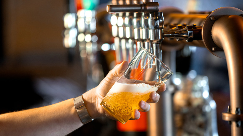 filling up a pint of beer from a tap