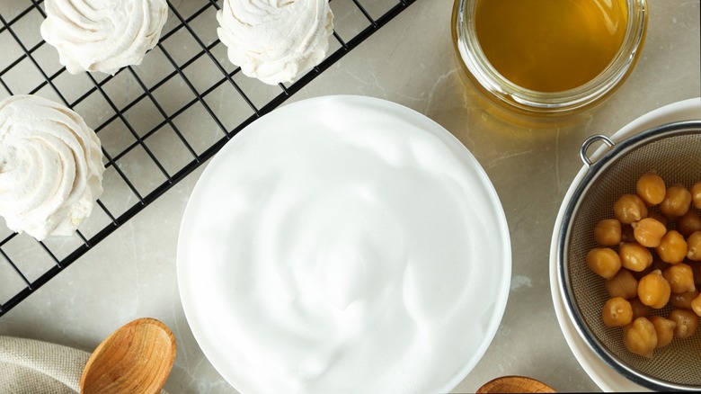 Aquafaba whipped in a bowl with chickpeas