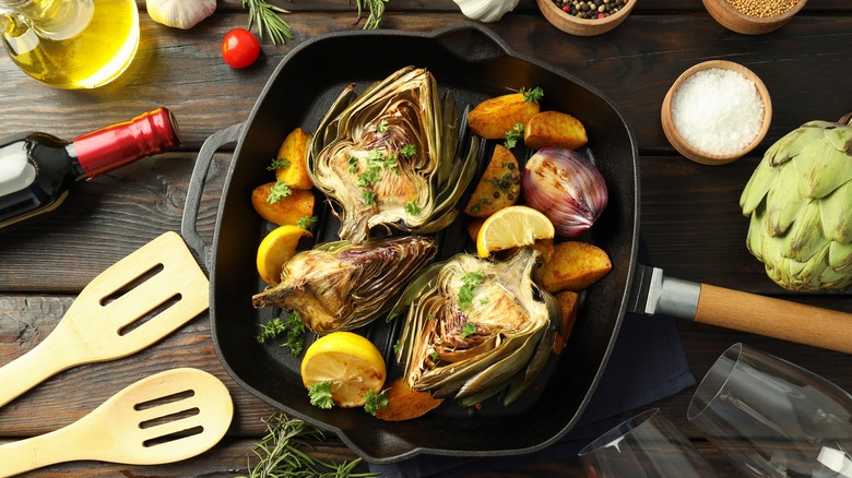 Artichokes and lemons on skillet