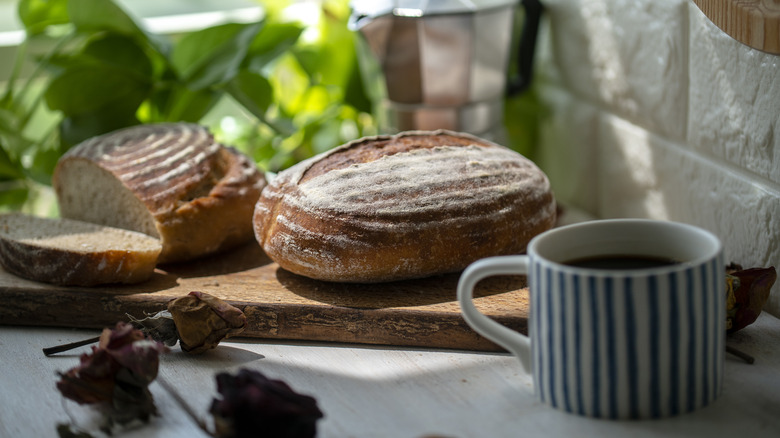 sourdough bread next to cup of coffee