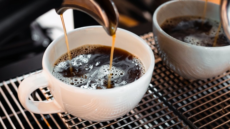 espresso brewing into coffee cup