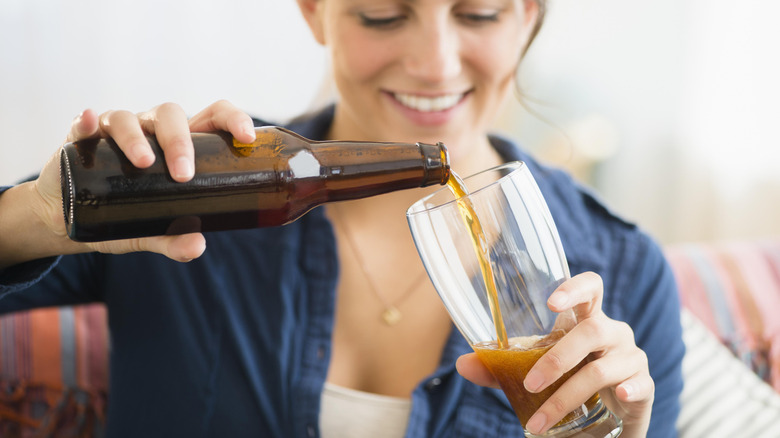 A woman pouring a pint of beer