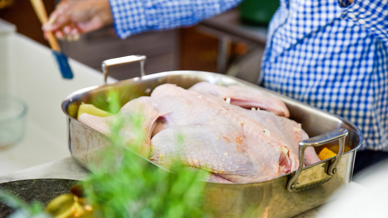 hands preparing turkey