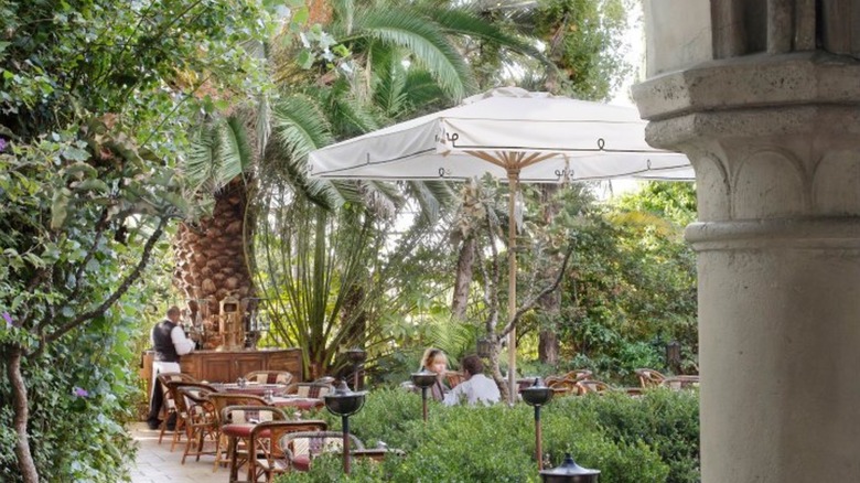 Chateau Marmont restaurant patio with white umbrella