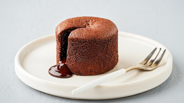A dessert fork next to a piece of cake