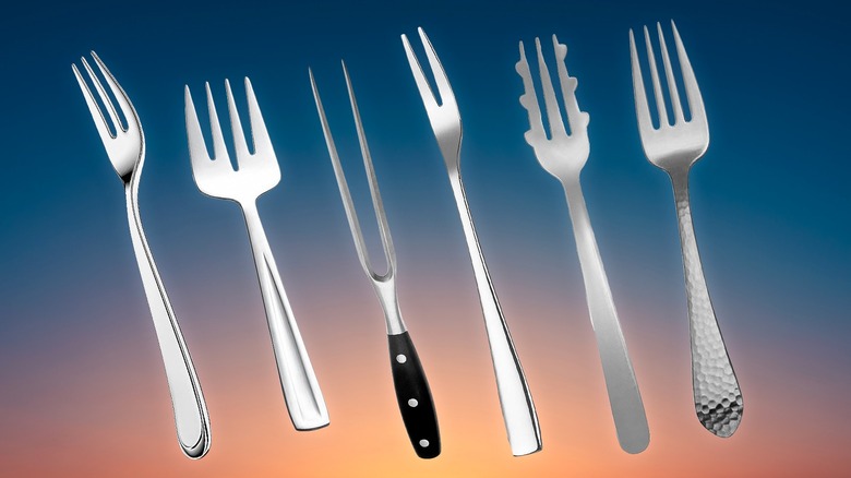 Several different types of forks on sunrise background