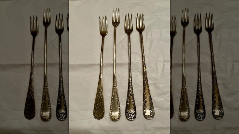 Four antique pickle forks