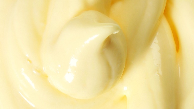 A close up of a dollop of creamy yellow mayonnaise