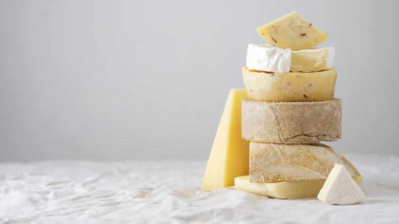 various cheeses stacked