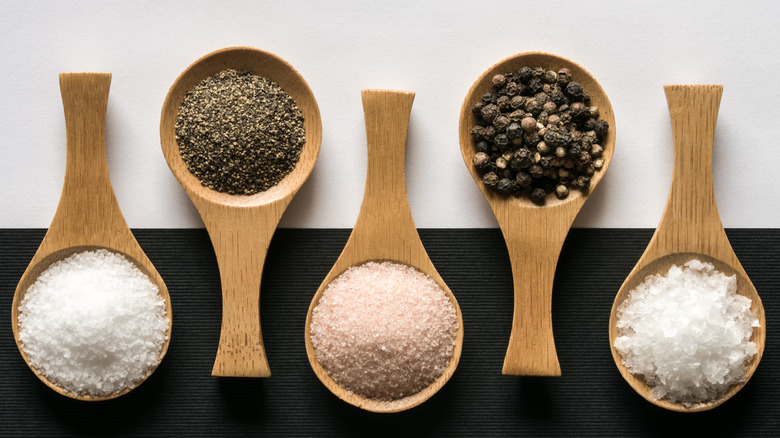 Salt and pepper on wooden spoons