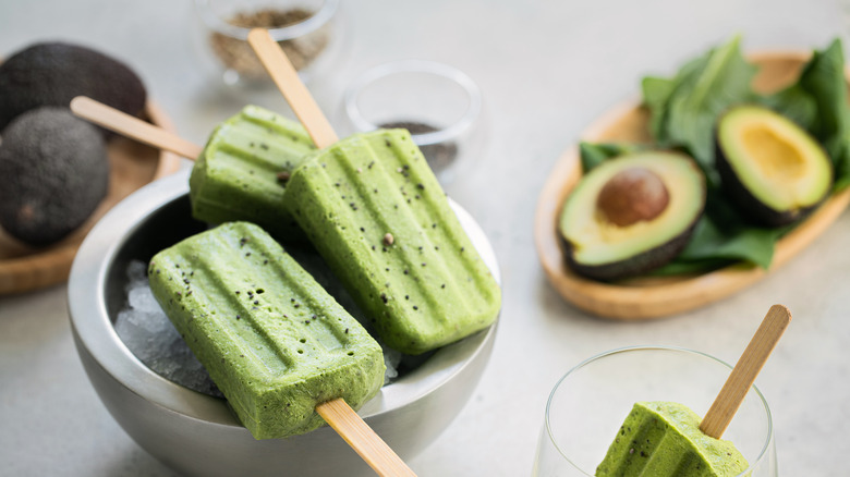 Spinach avocado popsicles on ice