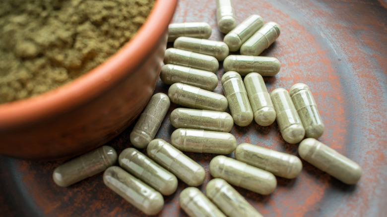 Green powder capsules on plate