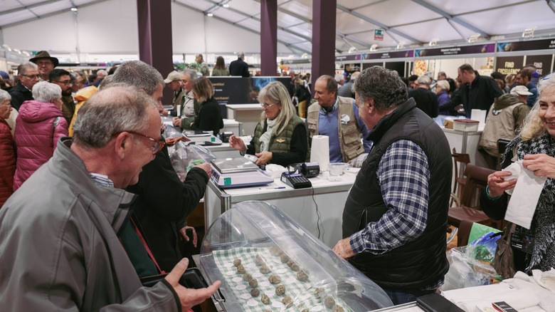 People buying truffles at fair