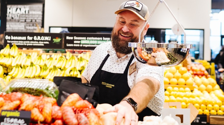 An employee in New Seasons Market produce section