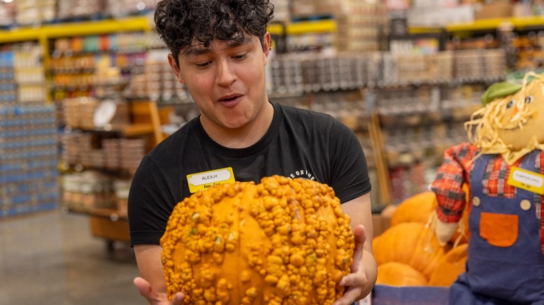 Nugget Markets employee with a knotty pumpkin