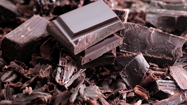 close-up of dark chocolate shavings, chocolate chunks, and chocolate bar pieces