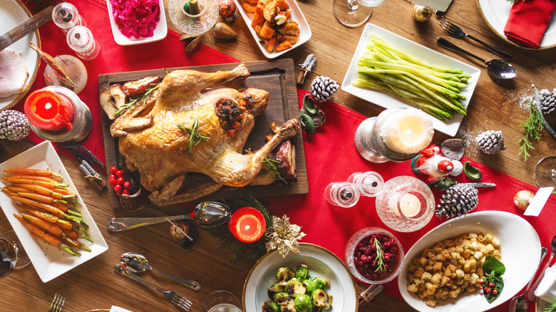 holiday dinner table with turkey and sides