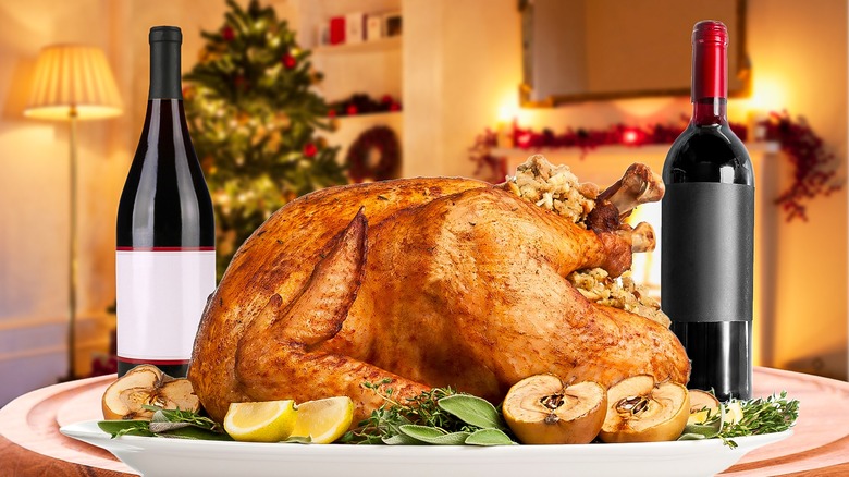 turkey and wine bottles on christmas table setting