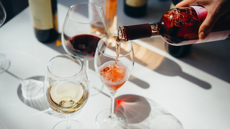 pouring wine in three glasses