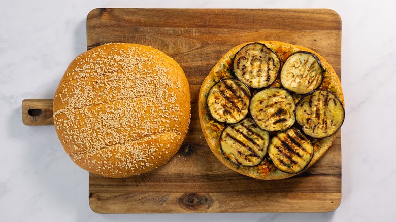 Overview of grilled eggplant slices on bun