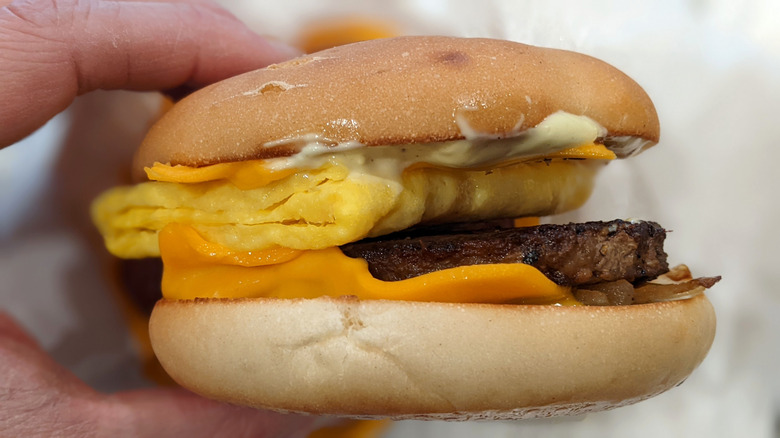 McDonald's Steak, Egg & Cheese Bagel in hand