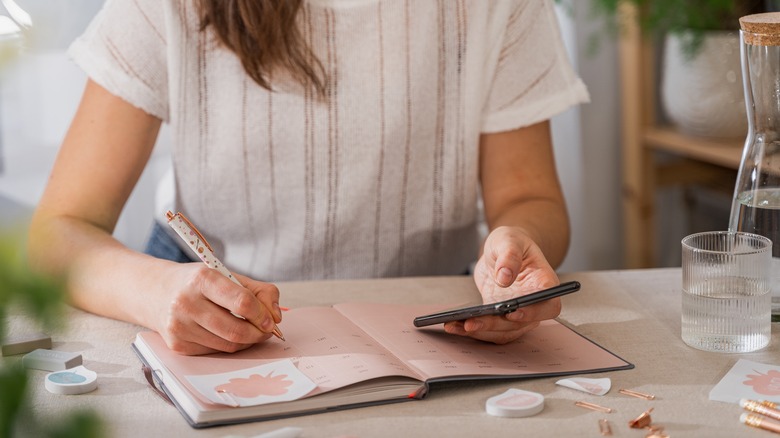 Woman writing in planner