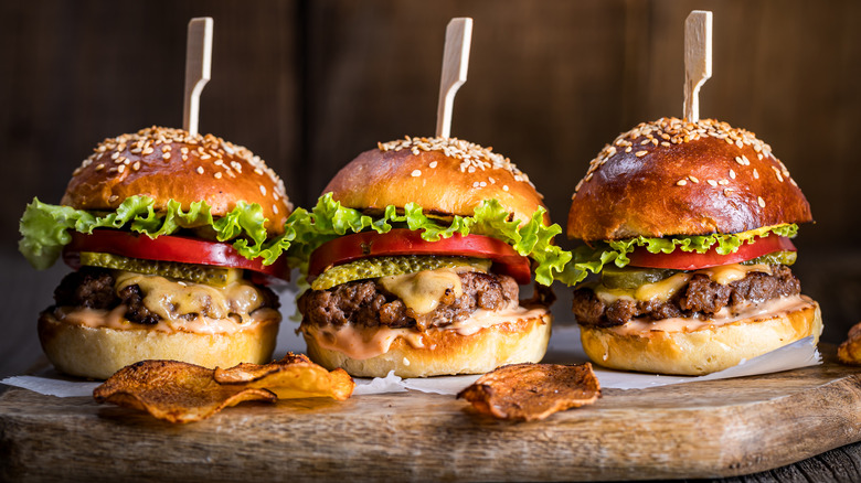 cheeseburgers on wooden board