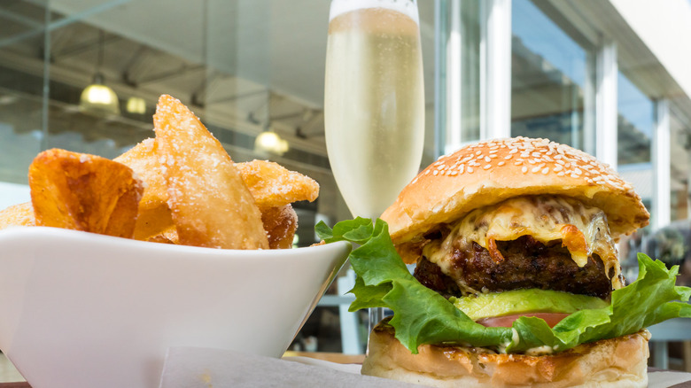 Cheeseburger with fries and Champagne