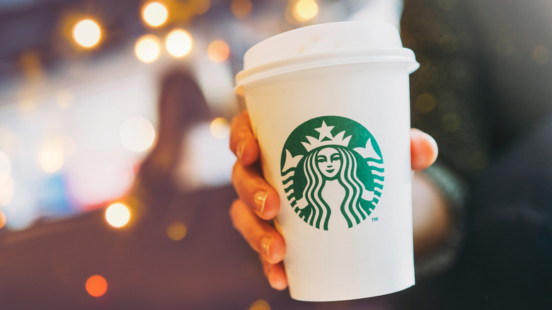 hand holding starbucks coffee cup