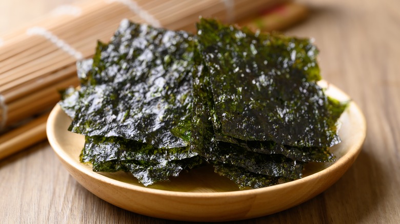 dried nori sheets in a bowl with bamboo mat