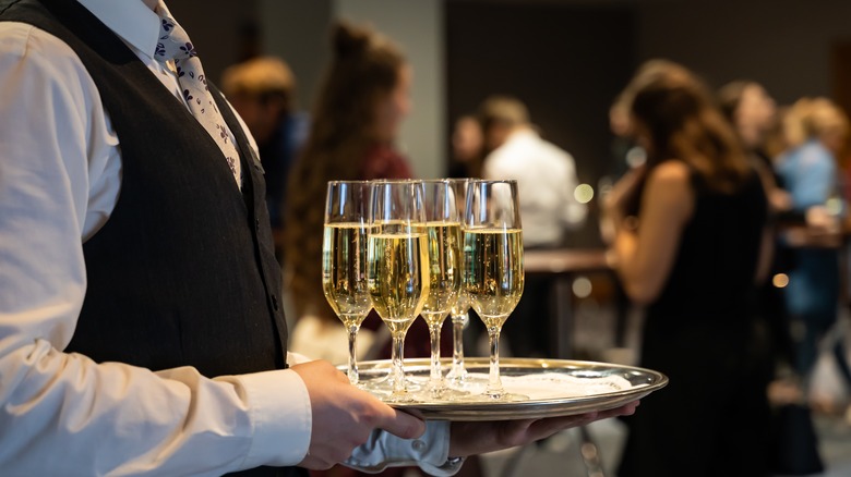 waiter with tray of champagne