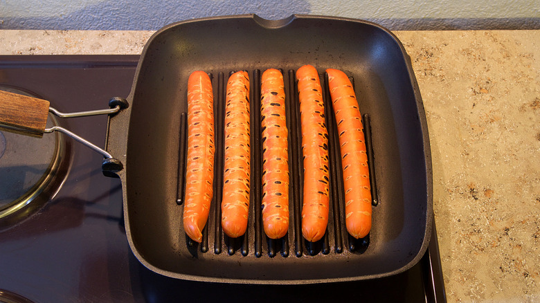 cooking hot dogs on a griddle