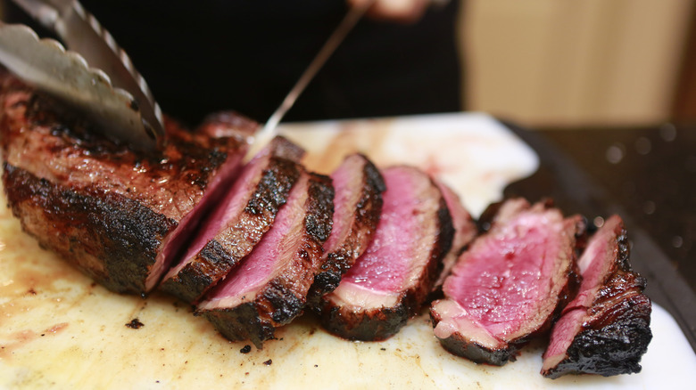 chef cutting cooked meat