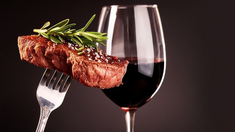 Steak on fork with wine