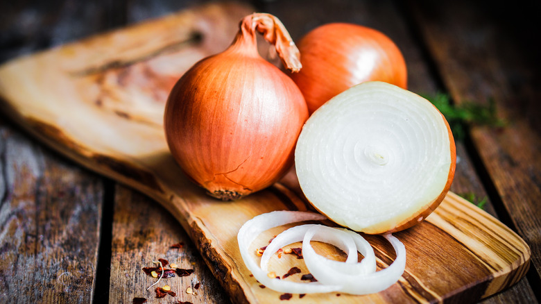 Onions sit on cutting board 