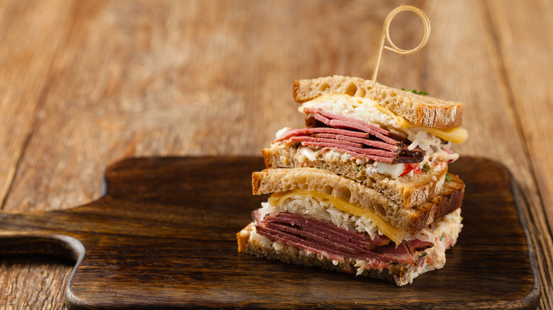 Reuben sandwich on a serving board.