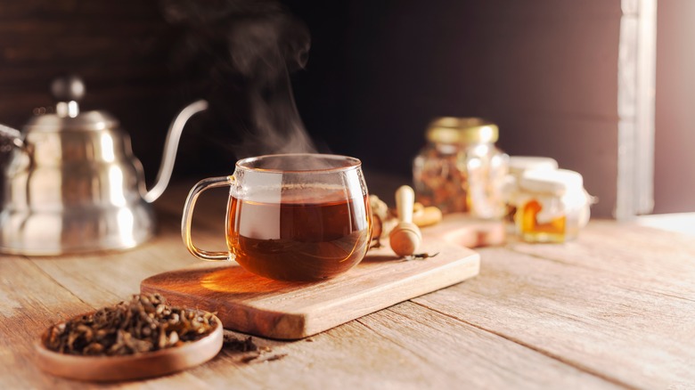 Black tea in cup with leaves