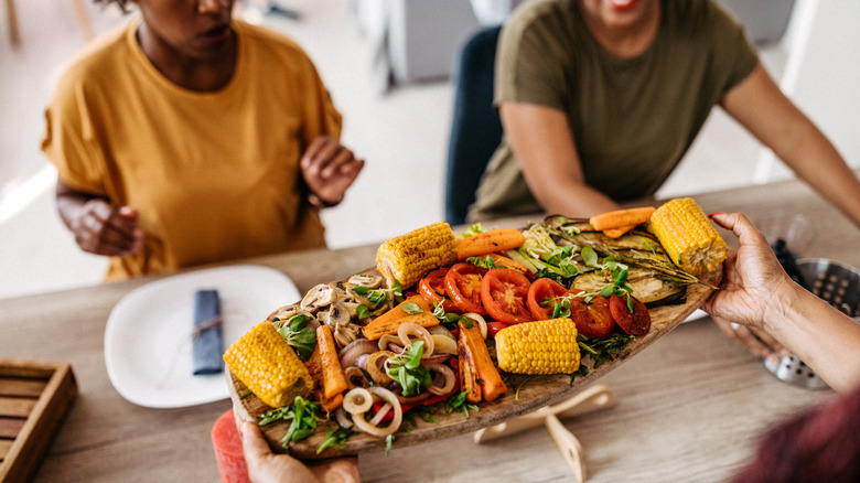 people being served vegetable platter