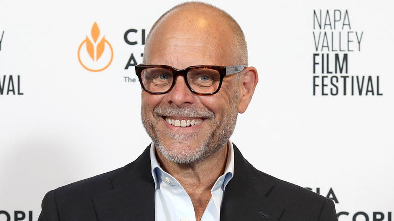 Alton Brown smiling on the red carpet at the Napa Valley Film Festival