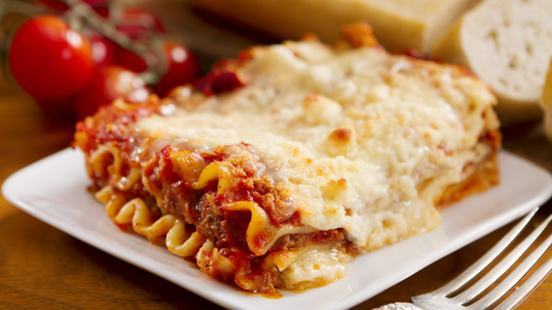 a single serving of meat lasagna on a white plate