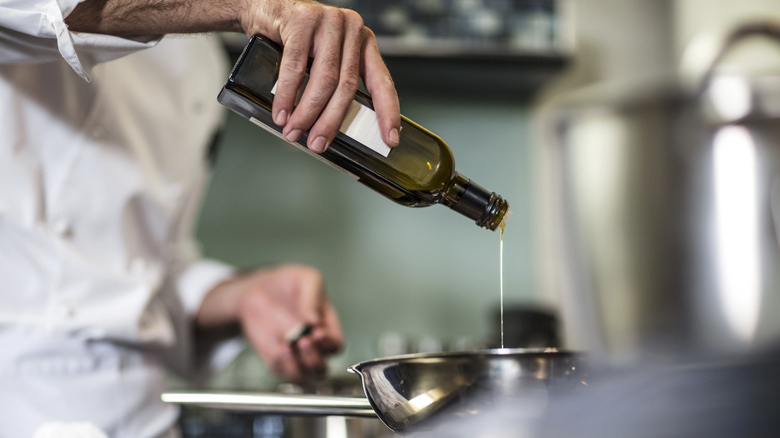 chef pouring oil