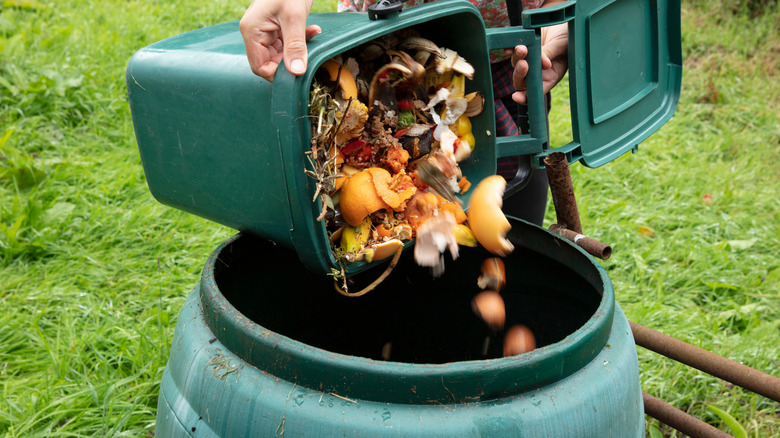 woman dumping compost into bin