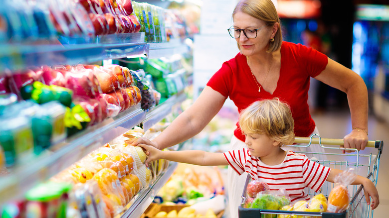 mom and son shopping refrigerated produce