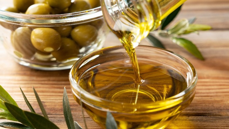 Olive oil being poured into a bowl 