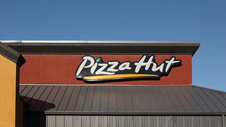 Pizza Hut logo on the side of a storefront