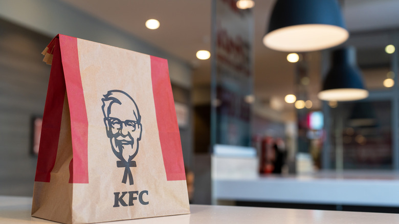 A KFC package bag on top of a table.