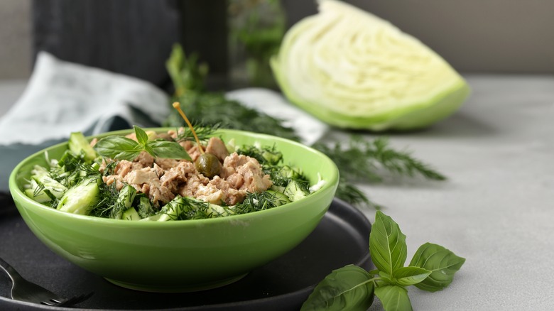 Tuna salad in bowl and wedge of cabbage